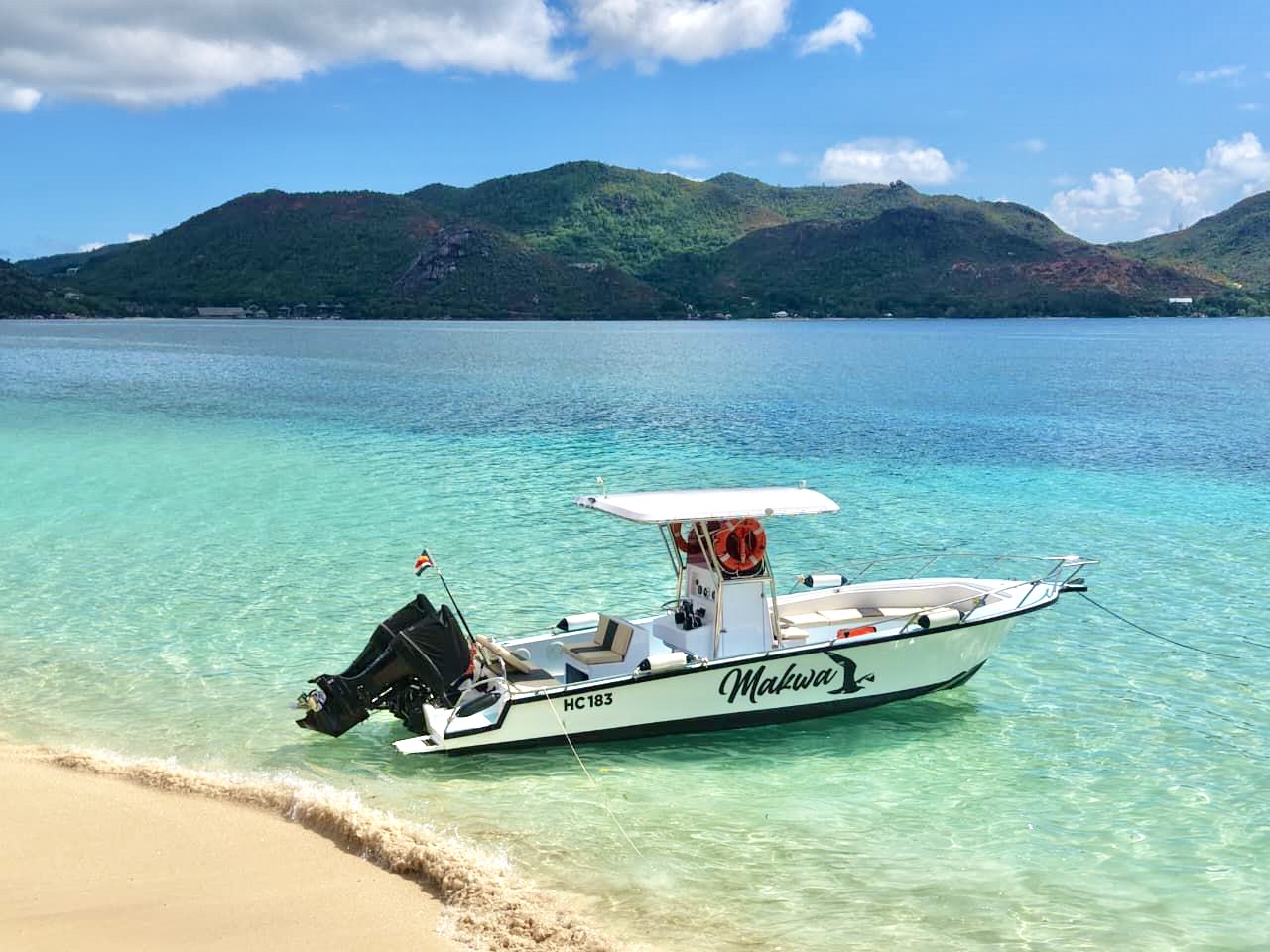 Makwa private charter boat on turquoise water in Praslin, Seychelles